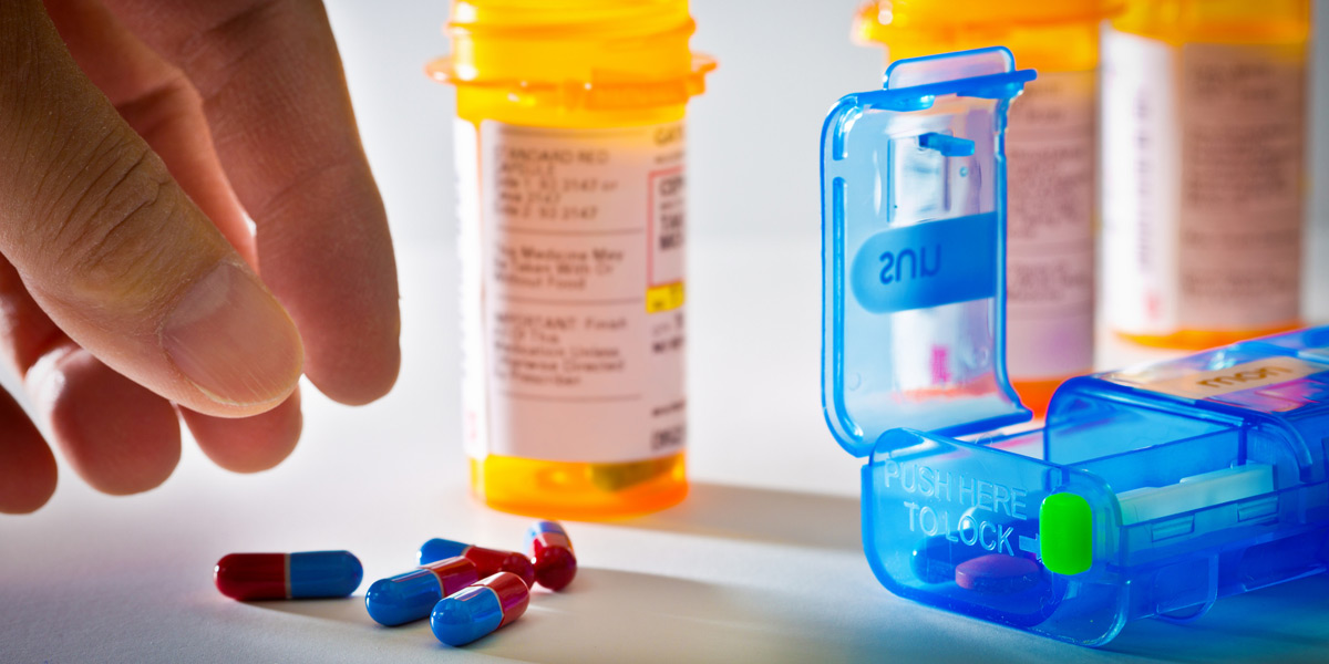 Hand-reaching-for-opioid-prescription-medication