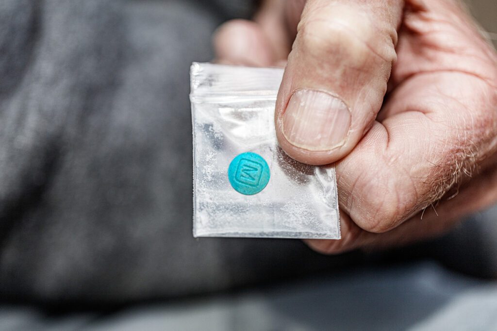 man-holding-fentanyl-in-plastic-bag