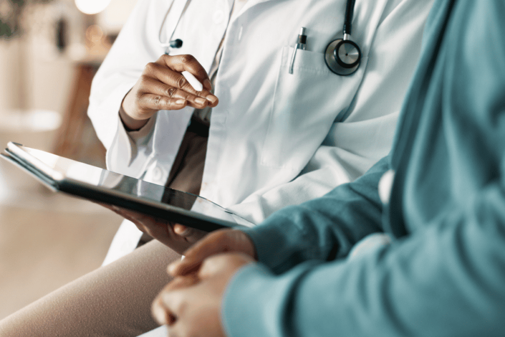 doctor with a stethoscope reviewing a chart with a patient doctor with a stethoscope reviewing a chart with a patient