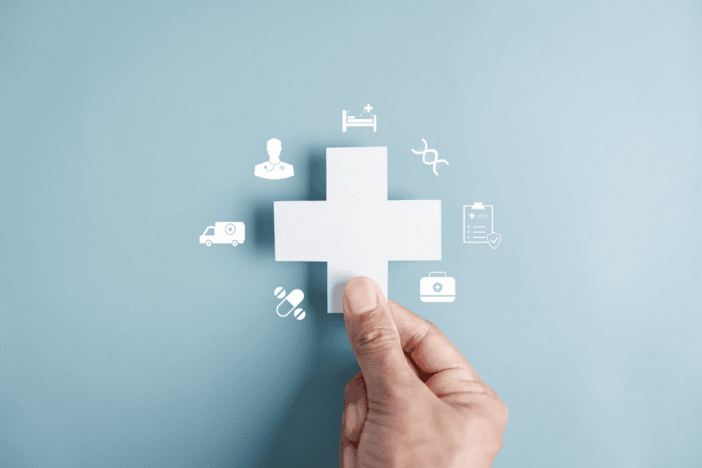 hand placing the final puzzle piece into a medical cross