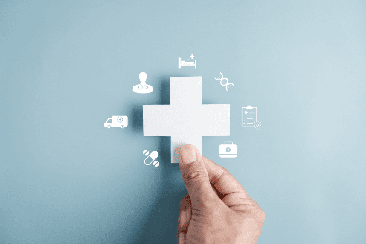 hand placing the final puzzle piece into a medical cross