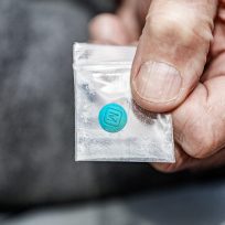 man-holding-fentanyl-in-plastic-bag